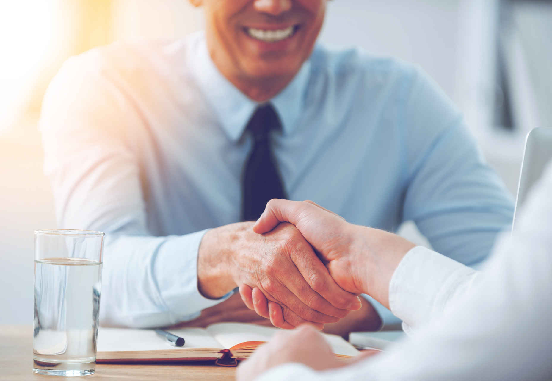 10 Popular Design Trends It’s Time to Let Die Good deal. Close-up of two business people shaking hands while sitting at the working place