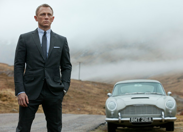James Bond posing with Vintage Aston Martin for Skyfall