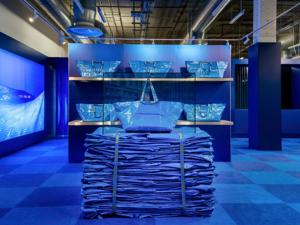 FRAKTA Reimagined: A Playful Tribute to IKEA’s Most Versatile Design front view of a stack of ikea frakta blue bags in a shop wit 1640dd1d7b3ea7f8dd77b27e8c695d93.jpg